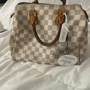 Its a Louis Vuitton Speedy Damier Azur 25 canvas satchel